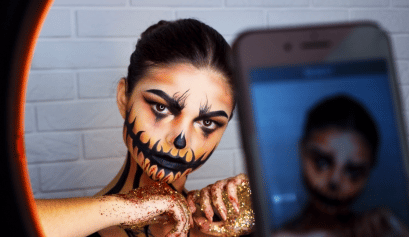 A client shows off her spooktastic look, a hot 2022 Halloween hair and makeup trend.