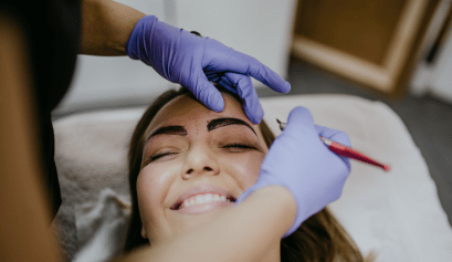 A client receives her microshading treatment while the cosmetologist performs her service with confidence because of her microshading insurance.