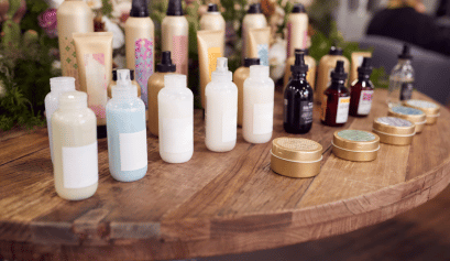 A line of products stack on a table at a cosmetologist's salon.