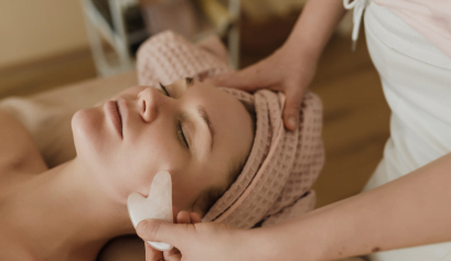 A customer receives an esthetician service as part of her customer gratitude package.