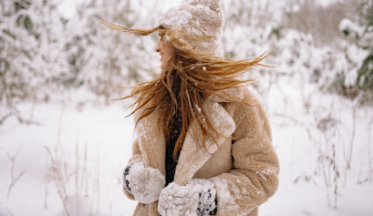 A client whips her around her in the middle of a snowy day, confident in her hair health thanks to her beauty pro's winter hair & skin tips.