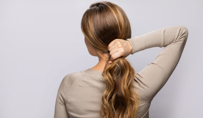 A client shows off her blond balayage look that her cosmetologist gave her after reading the EBS balayage guide.