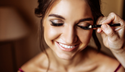 A cosmetologist works on her client's makeup as ponders about the tax write-offs she can use this tax season.