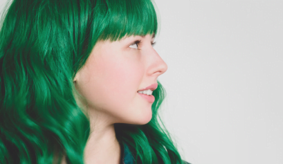A green-haired woman shows off her St. Patrick's Day look.