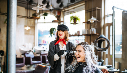 A hair dresser talks to her client about practicing cosmetology in another state.