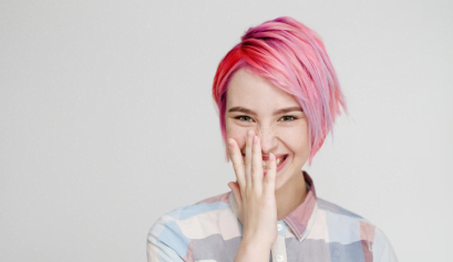 A client giggles while showing off her pink pixie cut, a warm weather style her hair stylist encouraged her to get.