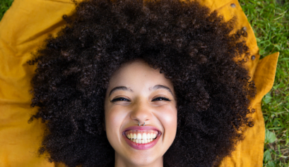 A cosmetologist smiles big after learning about the EBS Summer Refresh Giveaway.
