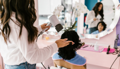 A client listens in as a hair stylist works on her hair and discusses what she should do with her tax refund.