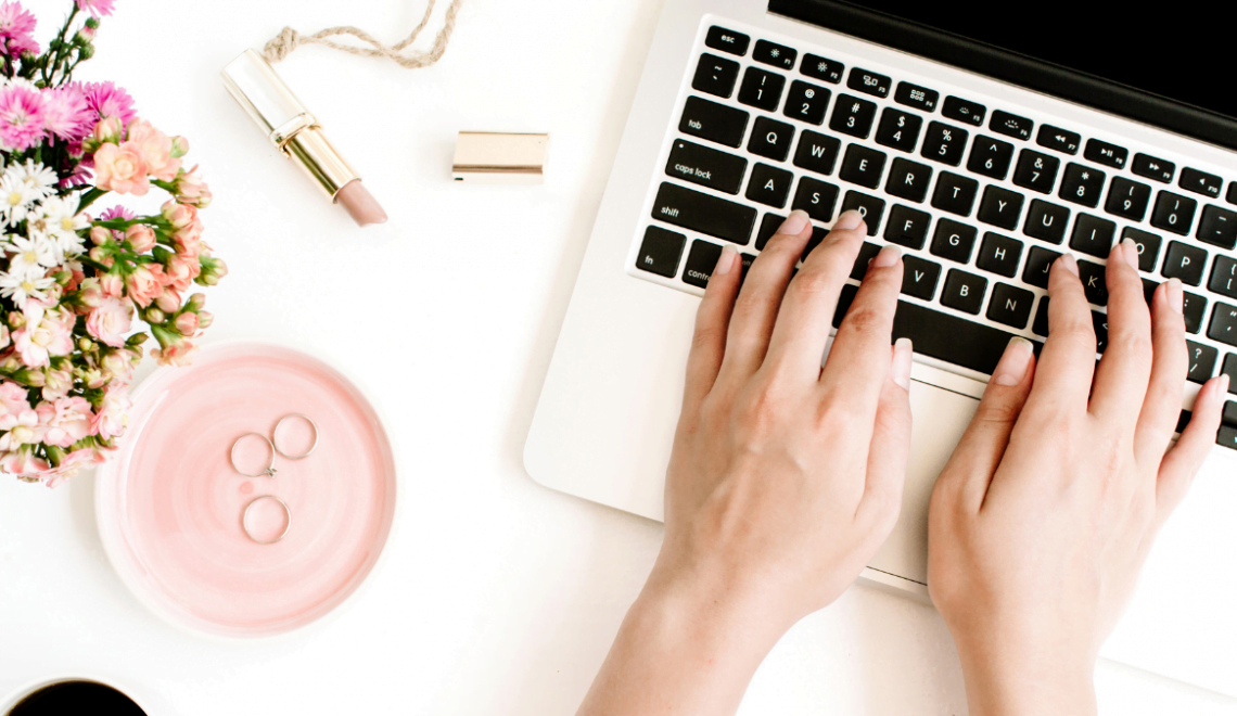 A cosmetologist works on booking her beauty business travel on her laptop.