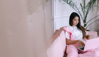 A beauty pro sits on a couch as she learns how to use AI in beauty shops.