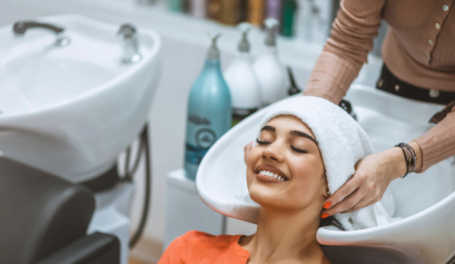 A client sits back and relaxes during her appointment, a long service she had to pay a down payment for.