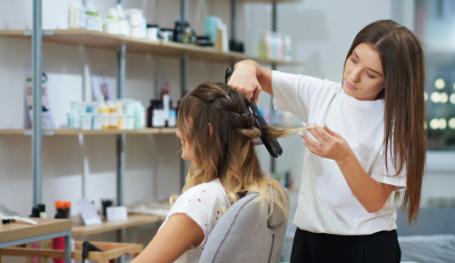 A client listens as her stylist discusses the latest beauty insurance claim she filed.