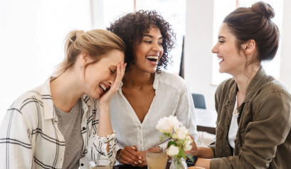 Several beauty pros sit around a table and brainstorm during their beauty agency session.