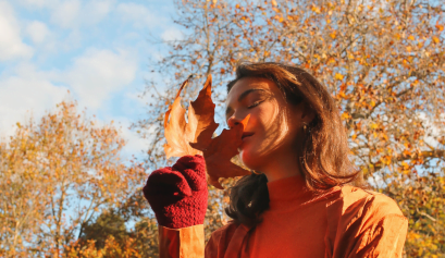 A cosmetologist uses an autumn leaf for inspiration as she gets hers fall salon ready for business.
