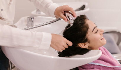 A client gets her hair done during a last-minute booking session during the holiday season.