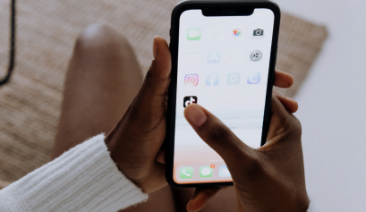 A cosmetologist opens TikTok shops on her phone to sell her products.