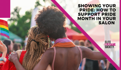 Two beauty pros lean in close and hold up Pride flags at a Pride Month celebration.